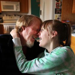 Doug Rice spends time with his daughter Ashley at their home in West Jordan on Wednesday, Nov. 16, 2016. Ashley receives three doses of CBD oil daily to treat her seizures.