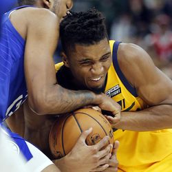Utah Jazz guard Donovan Mitchell and LA Clippers guard Tyrone Wallace wrestle for the ball during NBA action in Salt Lake City on Saturday, Jan. 20, 2018.