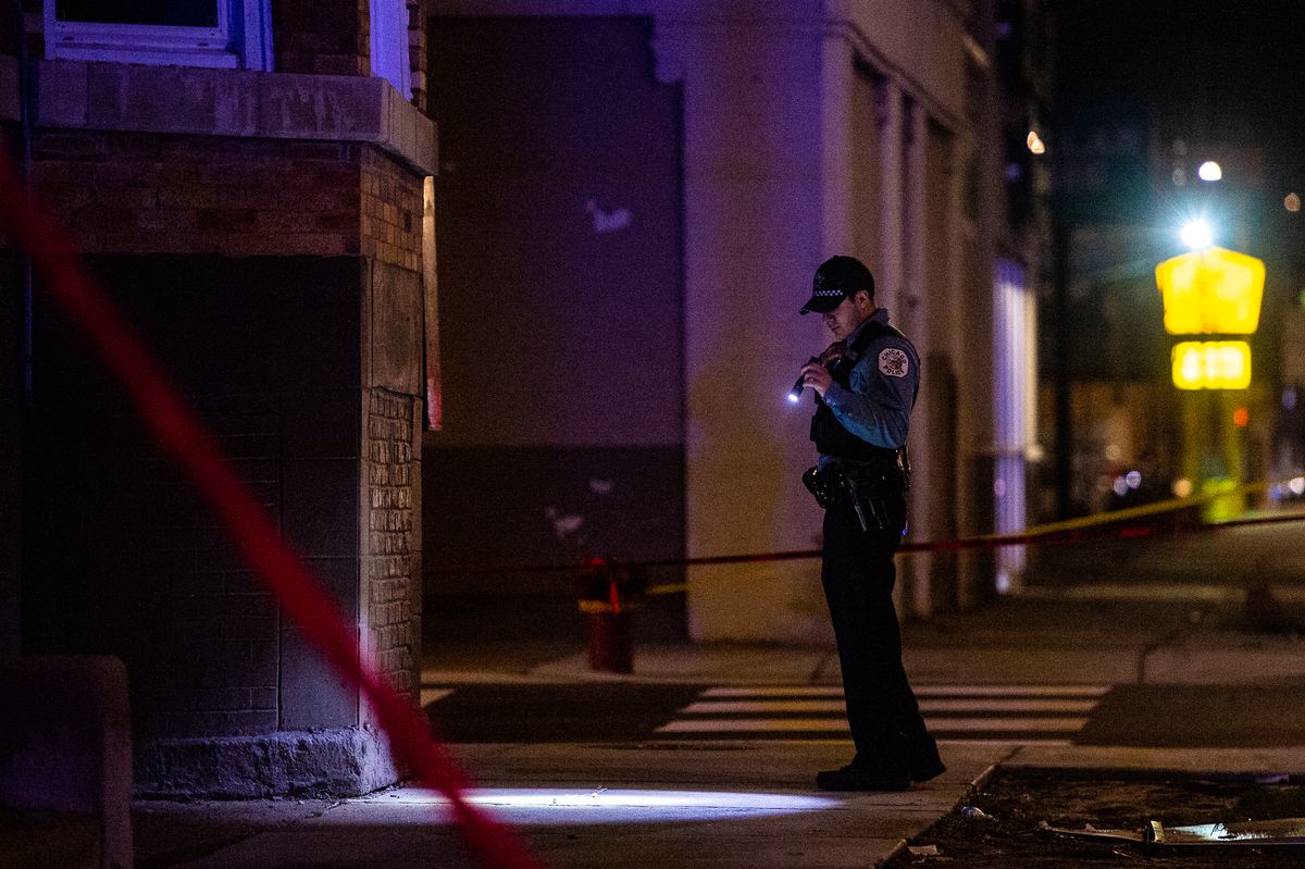 Chicago Police investigate the scene where a man was shot in the chest Monday morning in the Grand Crossing neighborhood. | Tyler LaRiviere/Sun-Times