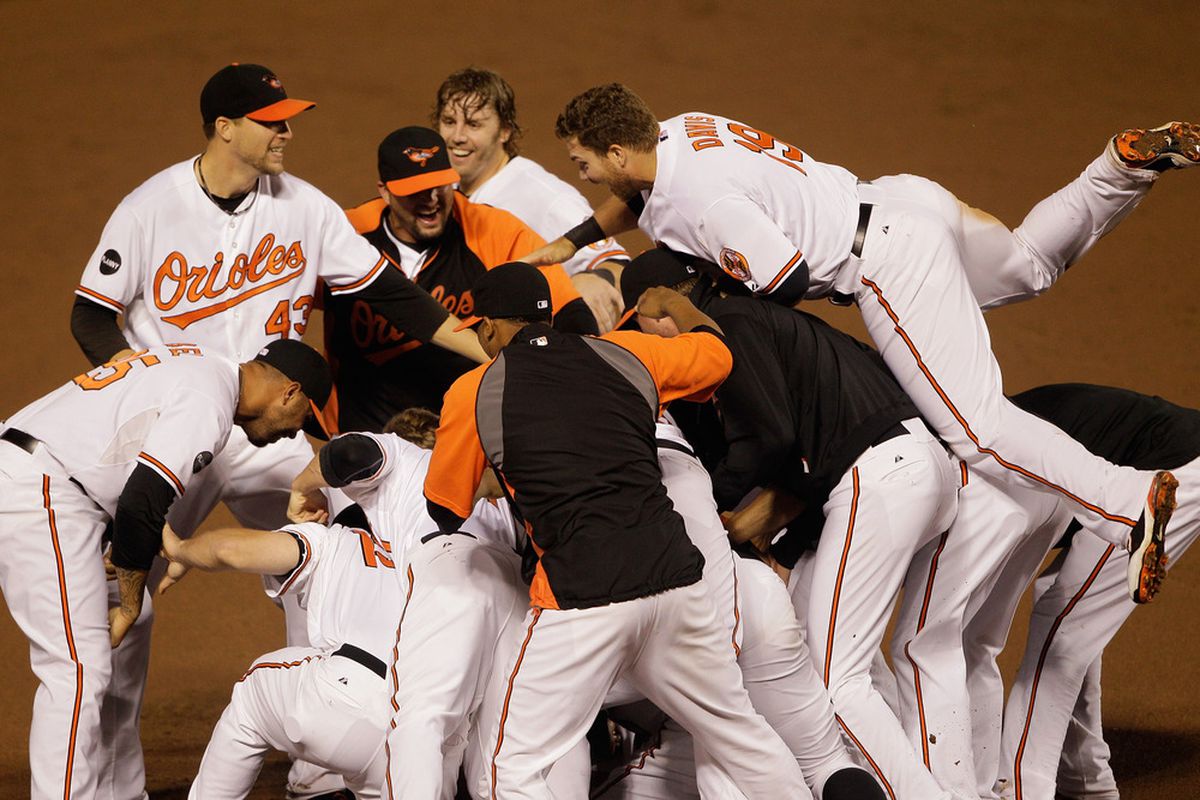 BALTIMORE, MD - SEPTEMBER 28:  Members of the Baltimore Orioles celebrate after defeating the Boston Red Sox 4-3 at Oriole Park at Camden Yards on September 28, 2011 in Baltimore, Maryland.  (Photo by Rob Carr/Getty Images)