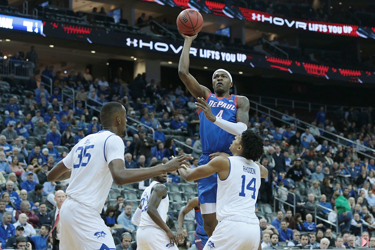 DePaul Blue Demons forward Paul Reed shoots the ball as Seton Hall Pirates guard Jared Rhoden  and center Romaro Gill defend during the first half at Prudential Center