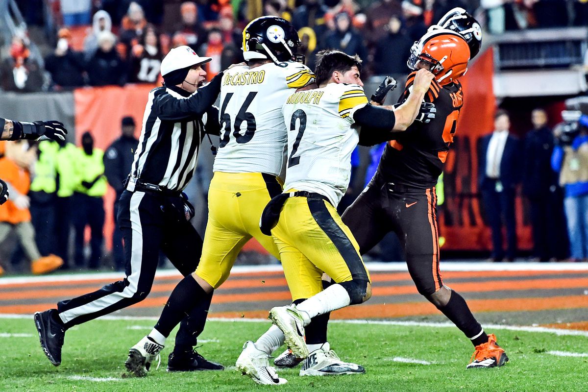 Cleveland Browns defensive end Myles Garrett hits Pittsburgh Steelers quarterback Mason Rudolph with his own helmet as offensive guard David DeCastro tries to stop Garrett during the fourth quarter at FirstEnergy Stadium.