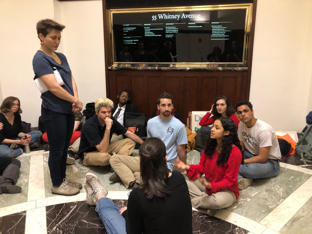 Divestment campaigners at Yale University stage a  sit-in at the school’s investments office on April 2, 2019.