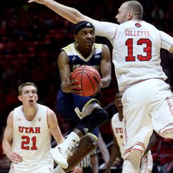 UC Davis Aggies guard Arell Hennings (4) ducks under the defense ofUtah Utes forward David Collette (13) as Utah and UC Davis play in an NIT basketball game at the Huntsman Center in Salt Lake City on Wednesday, March 14, 2018. Utah won 69-59.