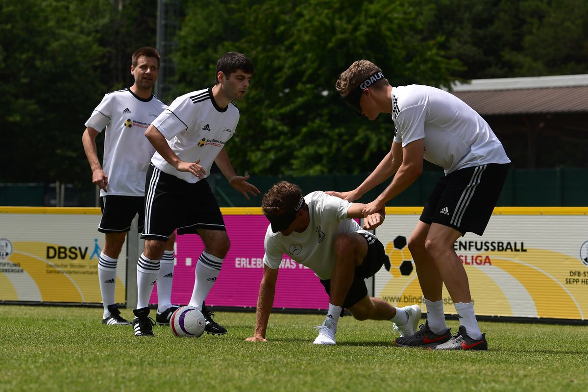 FBL-WC-2018-GER
(L-R) Members of the German football national blind team Alexander Fangmann and Ali Pektas, Germany's forward Thomas Müller and Germany's midfielder Matthias Ginter take part in a blind football demonstration at the Rungghof training center on May 31, 2018 in Girlan, near Bolzano, northern Italy, ahead of the FIFA World Cup 2018 in Russia. - The 'Mannschaft' will train in Rungghof until June 7, 2018.