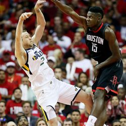 Utah Jazz forward Joe Ingles (2) passes the ball away from Houston Rockets center Clint Capela (15) as the Utah Jazz and the Houston Rockets play game two of the NBA playoffs at the Toyota Center in Houston on Wednesday, May 2, 2018.