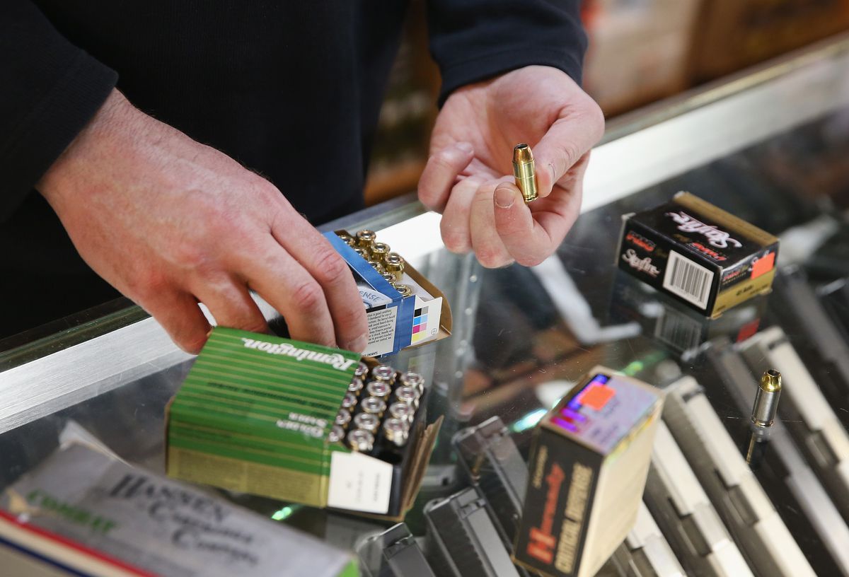 Craig Marshall helps a customer shop for ammunition at Freddie Bear Sports in 2014.