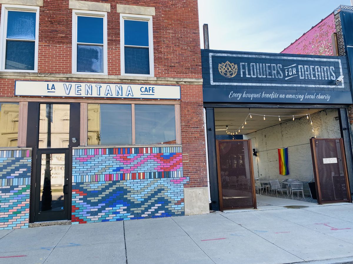 A building with brick and multi-colored tiles, and a sign that says La Ventana Cafe in Detroit, Michigan.