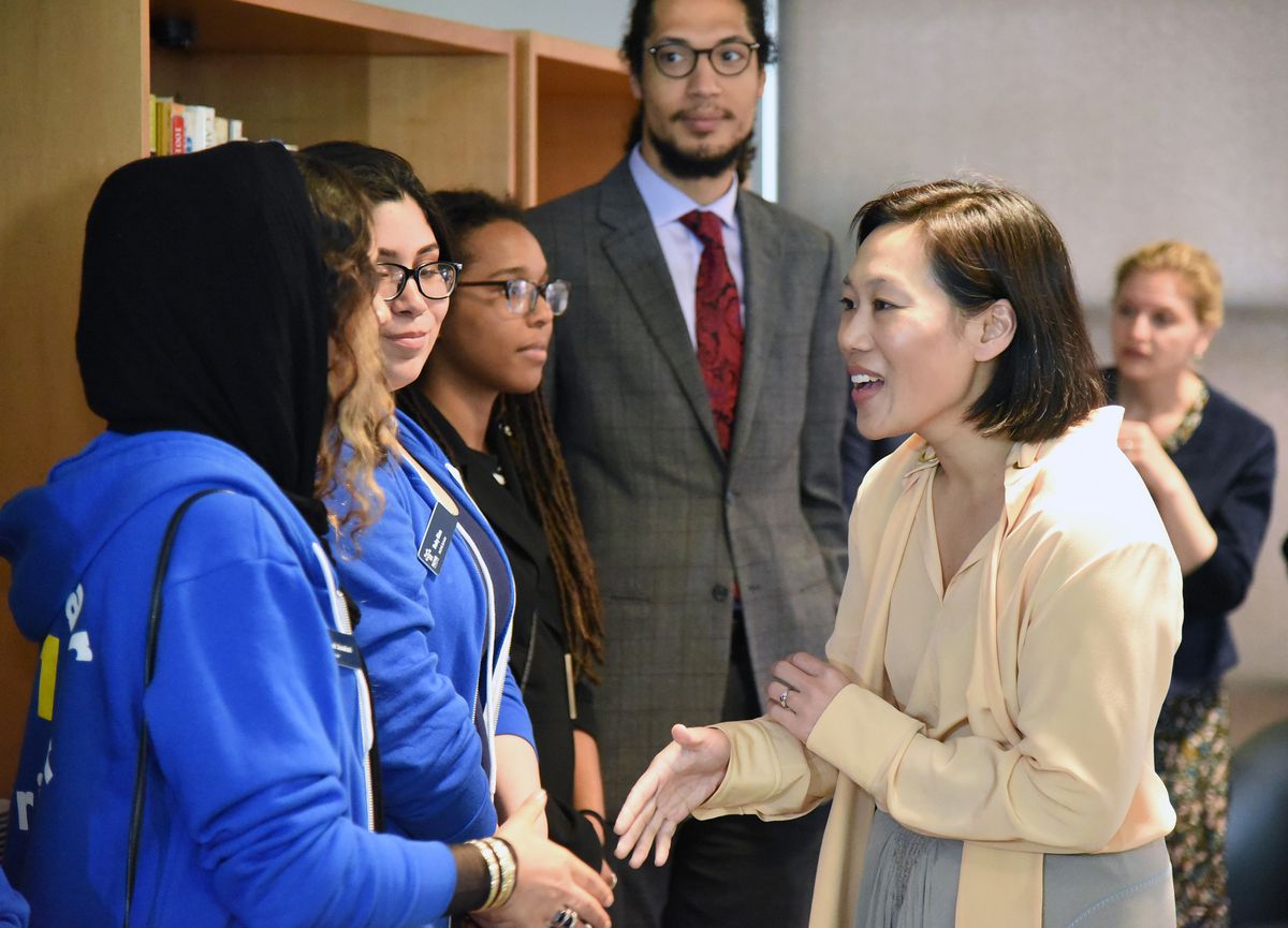 Priscilla Chan shaking hands with UCSD science undergraduates in 2019.