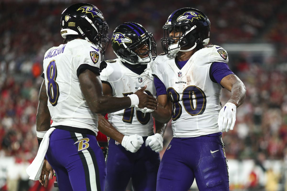 Isaiah Likely #80 of the Baltimore Ravens celebrates with Demarcus Robinson #10 and Lamar Jackson #8 after scoring a touchdown during the third quarter of an NFL football game against the Tampa Bay Buccaneers at Raymond James Stadium on October 27, 2022 in Tampa, Florida.