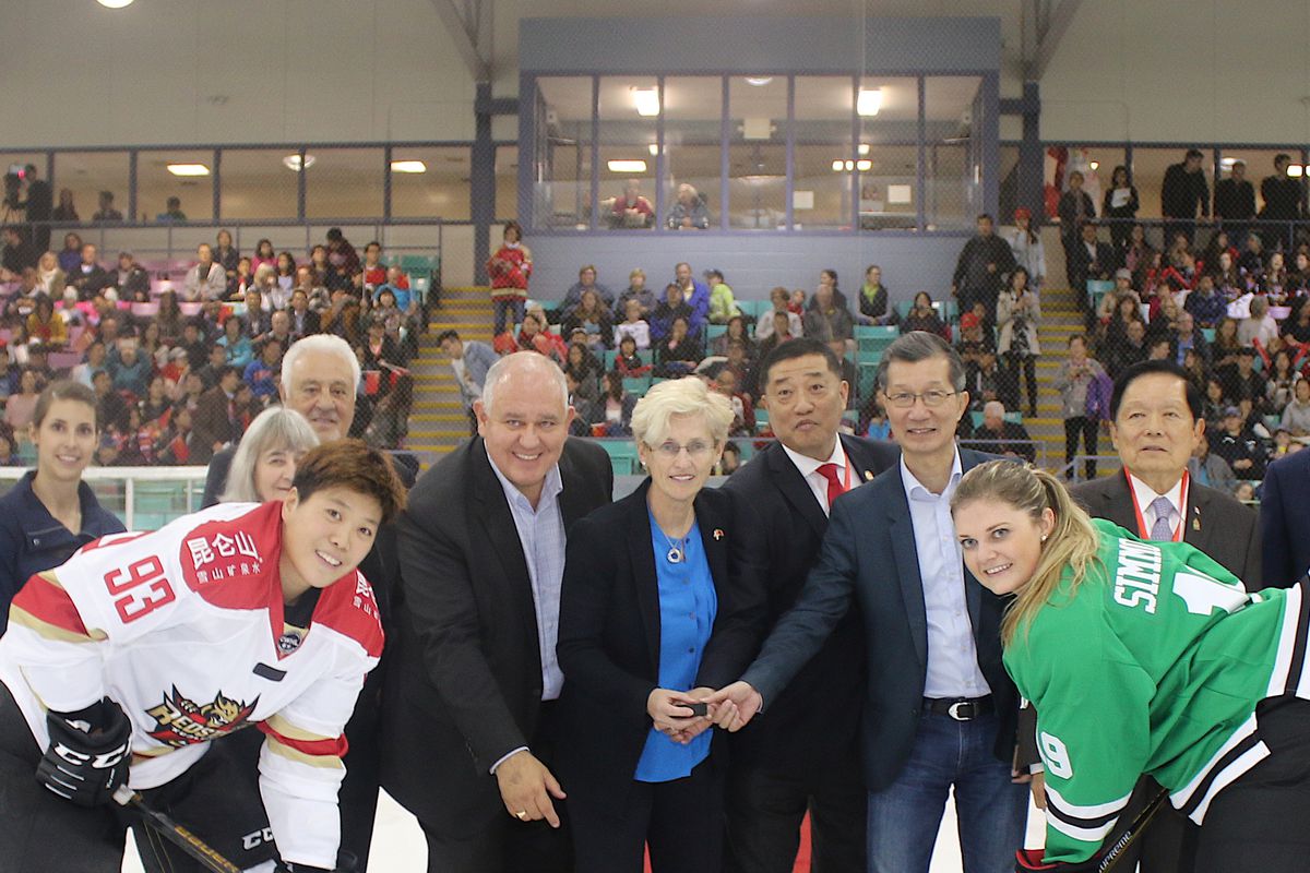 CWHL Commissioner Brenda Andress (centre) participates in the ceremonial faceoff at Kunlun Red Star’s inaugural game.