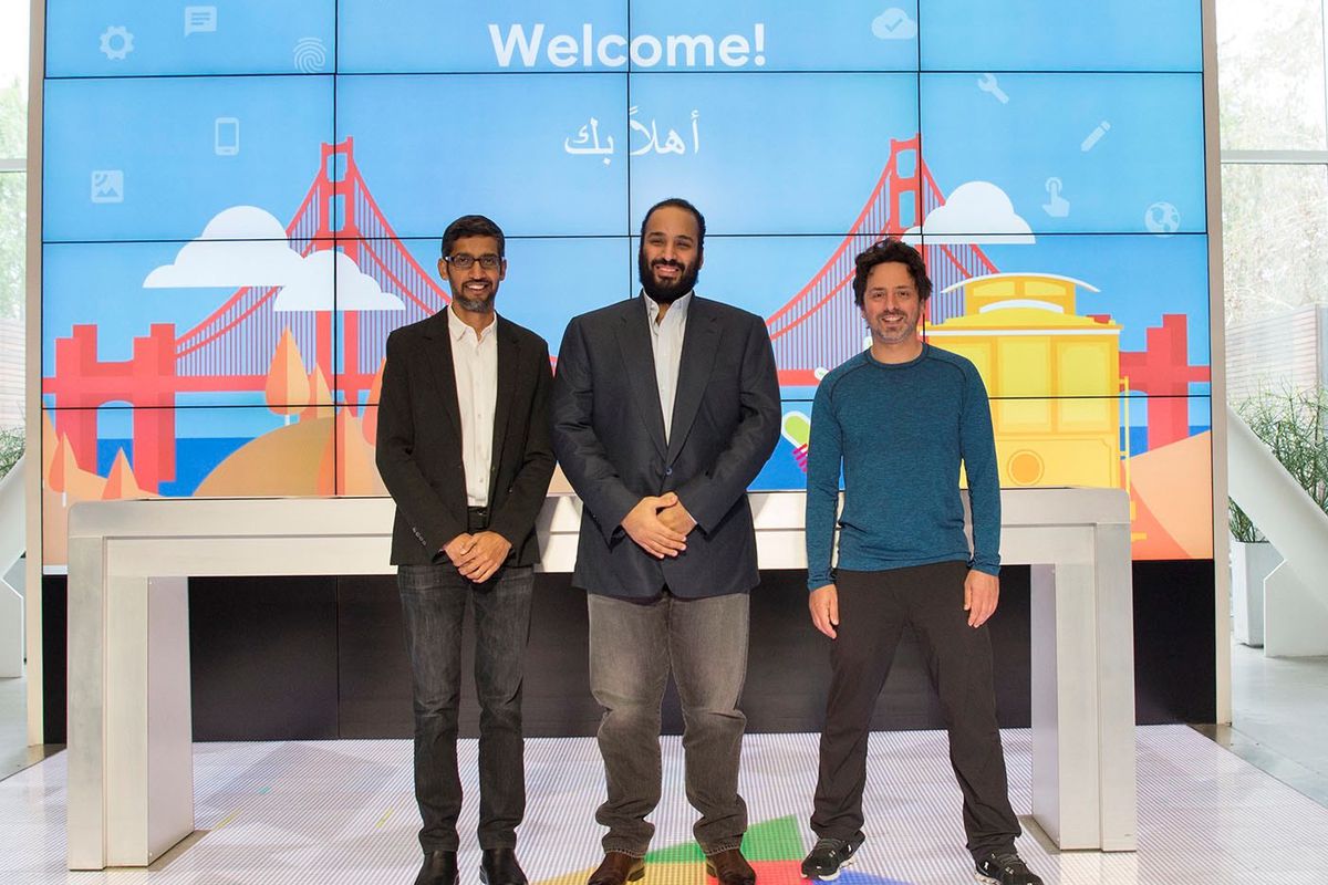 left to right: Google CEO Sundar Pichai, Saudi Crown Prince Mohammed bin Salman and Google co-founder Sergey Brin pose in front of a “Welcome” sign decorated with a drawing of the Golden Gate Bridge and a cable car.