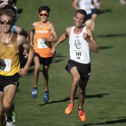 Corner Canyon High School’s Caleb Johnson, right, races to the finish line during the boys varsity 5K during the BYU Autumn Classic Cross Country Invitational at the East Bay Golf Course Saturday, Sept. 14, 2019 in Provo.