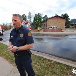 South Davis Metro Fire Chief Jeff Bassett talks with media as firefighters respond to a structure fire in Bountiful, Thursday, March 17, 2016.
