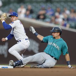 Seattle Mariners catcher Cal Raleigh (29) slides to second base against Chicago Cubs second baseman Nico Hoerner (2) after hitting a double during the first inning at Wrigley Field.