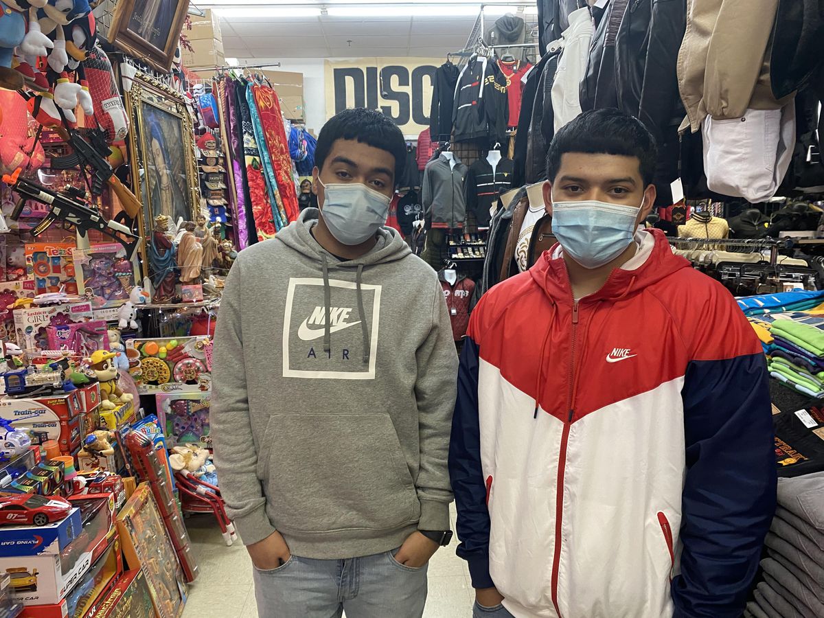 Jonathan Escalante (right) and David Dominguez inside the Discount Mall, 3115 W. 26th St., on Dec. 16, 2020.