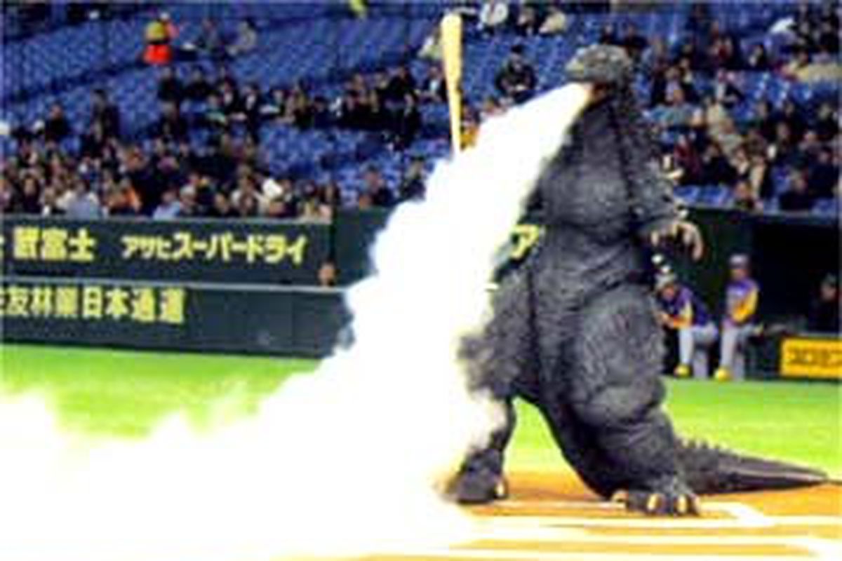 This is the best picture I could find of godzilla mascots playing baseball. Sucks I know.