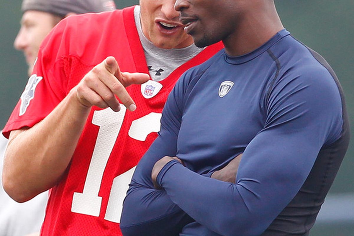 FOXBOROUGH, MA  - JULY 29:  Tom Brady #12 and Chad Ochocinco of the New England Patriots chat during training camp at Gillette Stadium on July 29, 2011 in Foxborough, Massachusetts.  (Photo by Jim Rogash/Getty Images)