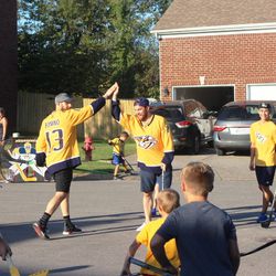 Nick Bonino and Yannick Weber high-five while playing street hockey with local fans in Nolensville.