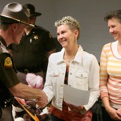 Utah Highway Patrol Maj. Michael Rapich honors Jan Gray and Kaye Nelson after they helped collect 2,000 stuffed animals to donate in memory of fatal crash victim Stacie Mae Gray, Jan's daughter and Kaye's niece, at Utah Highway Patrol Headquarters in Salt Lake City on Thursday, April 4, 2013. The stuffed animals are used to comfort children involved in car crashes and also distributed at car seat checkpoints to reward children for buckling up.
