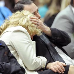 Nanette Wride is consoled by her son Nathan Mohler, right, and family as one of her other sons, Tyesun Wride, sits by her side during the funeral service for her late husband, Utah County Sheriff's Sgt. Cory Wride, at the UCCU Events Center in Orem on Wednesday, Feb. 5, 2014.