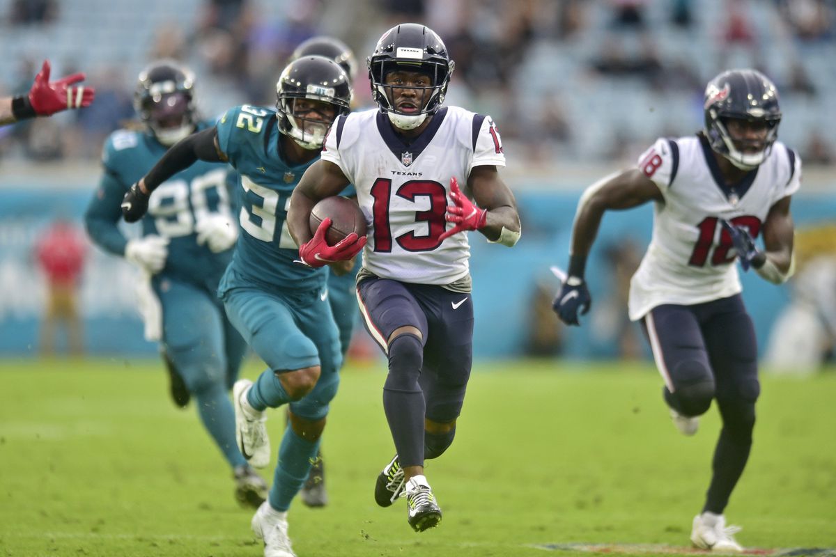 Houston Texans wide receiver Brandin Cooks (13) scores the final touchdown for Houston as Jacksonville Jaguars cornerback Tyson Campbell (32) can’t make the tackle during the fourth quarter Sunday, Dec. 2021 at TIAA Bank Field in Jacksonville.