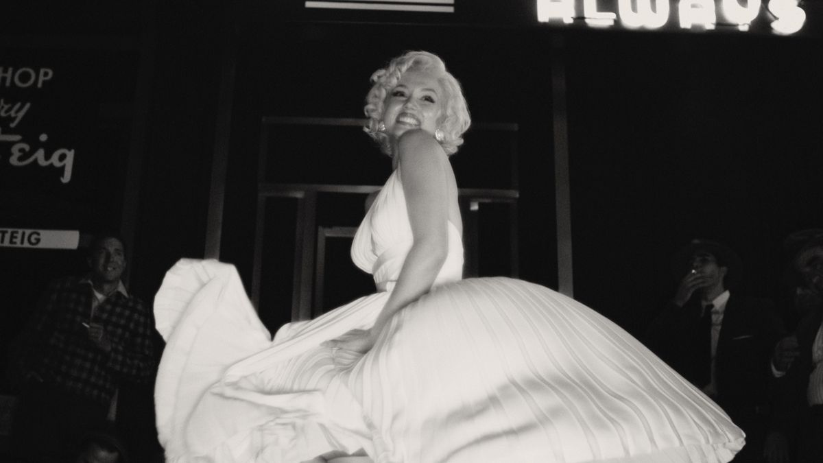 Ana de Armas as Marilyn Monroe, in black and white, as her iconic white dress from The Seven Year Itch billows around her