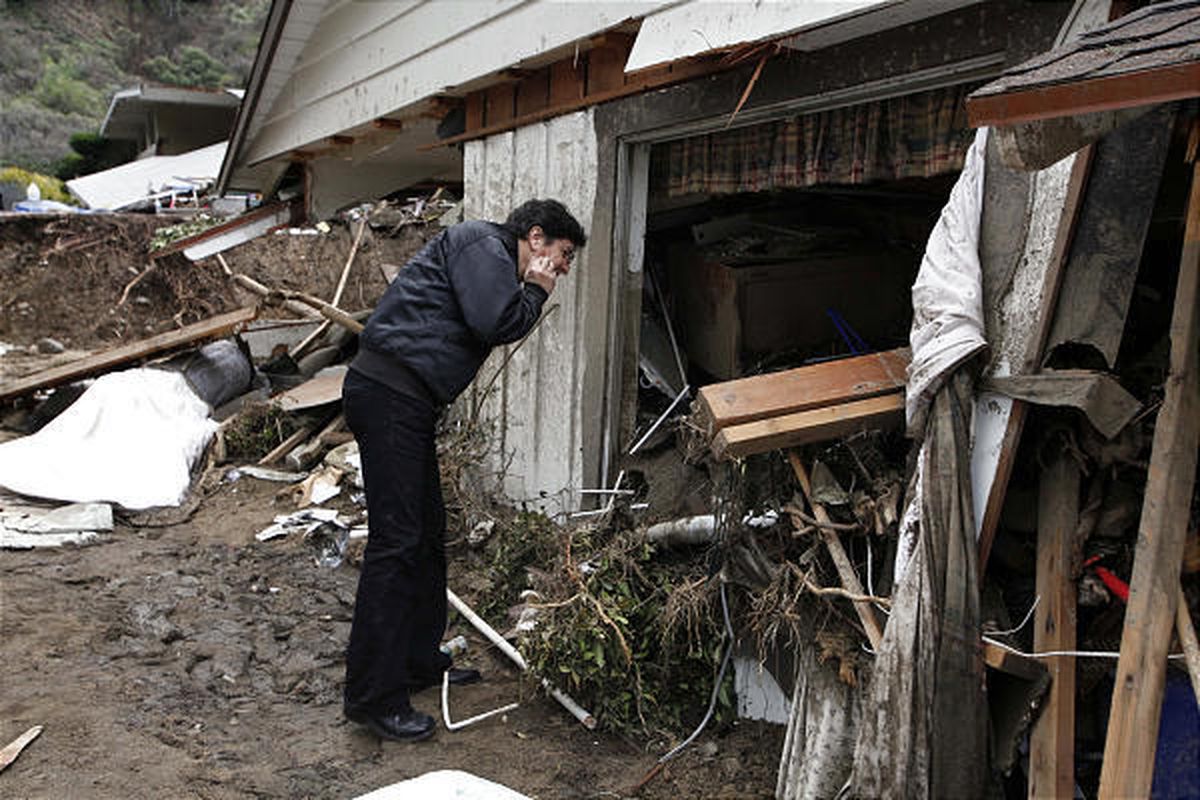 Henry Laguna looks at his mud-damaged home Tuesday in La Canada Flintridge.