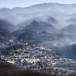 In this aerial photo, smoke rise above Gatlinburg, Tenn., Tuesday, Nov. 29, 2016, the day after a wildfire destroyed numerous homes and buildings. 