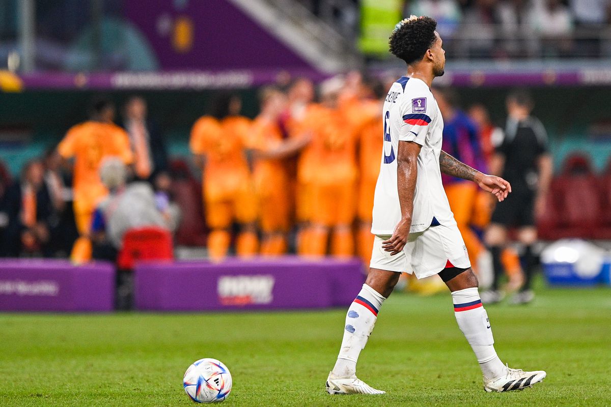 Jesus Ferreira of USA looks dejected while Daley Blind of the Netherlands celebrates after scoring his sides second goal during the Round of 16 - FIFA World Cup Qatar 2022 match between Netherlands and USA at the Khalifa International Stadium on December 3, 2022 in Doha, Qatar.