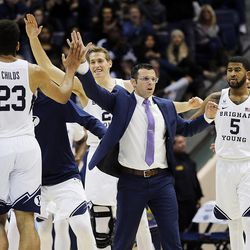 BYU players and coaches celebrate near the end of the game against Colorado during an NCAA basketball game in Provo on Saturday, Dec. 10, 2016.