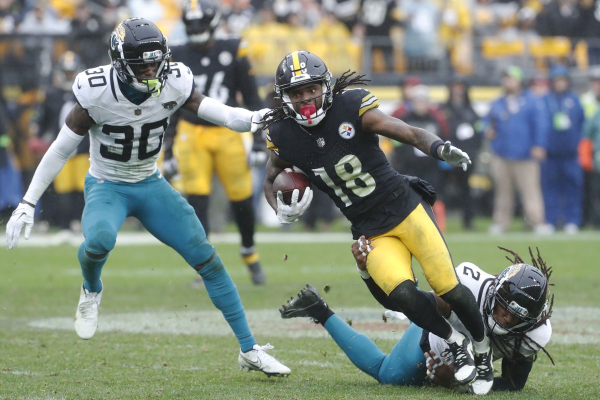 Pittsburgh Steelers wide receiver Diontae Johnson (18) runs after a catch as Jacksonville Jaguars safety Rayshawn Jenkins (2) and cornerback Montaric Brown (30) defend during the third quarter at Acrisure Stadium.&nbsp;