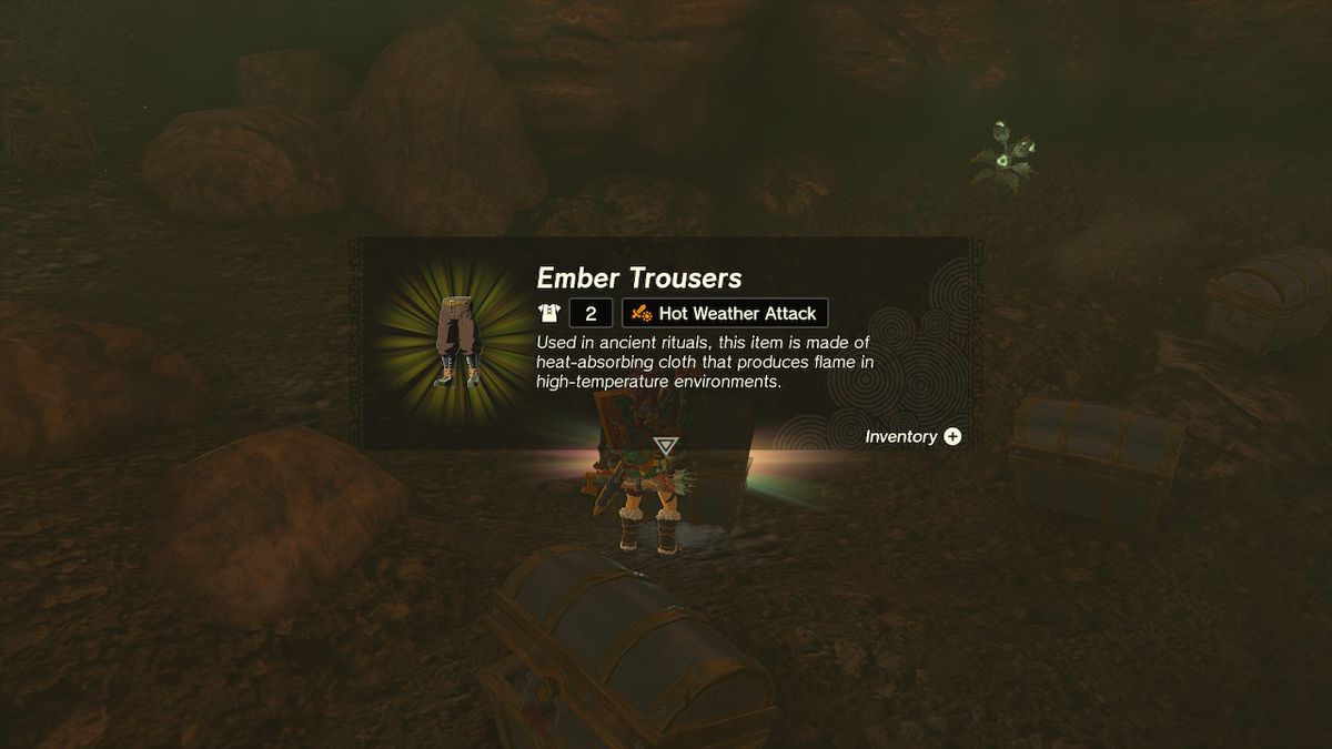 Link picks up the Ember Trousers from inside the chest in Zelda: Tears of the Kingdom