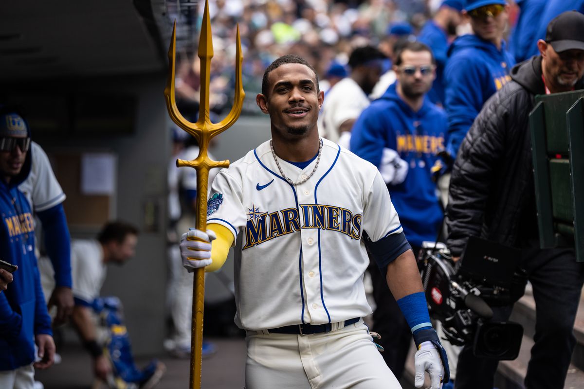 Julio Rodriguez of the Seattle Mariners poses with a trident in the dugout after hitting a solo home run against the Houston Astros during the second inning at T-Mobile Park on May 7, 2023 in Seattle, Washington.