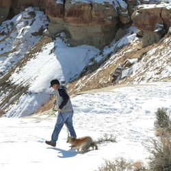 A man walks with his dog near Salt Wash in Emery County on Feb 23, 2019. The area has been designated as wilderness and for a new national monument under the proposed Natural Resources Management Act.