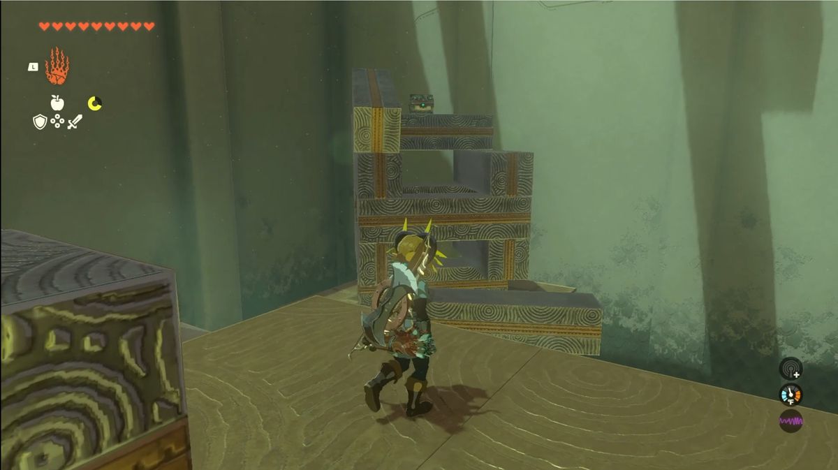Link looks a stack of blocks, half demolished, with a treasure chest on top in the Jochi-iu Shrine in Zelda: Tears of the Kingdom.