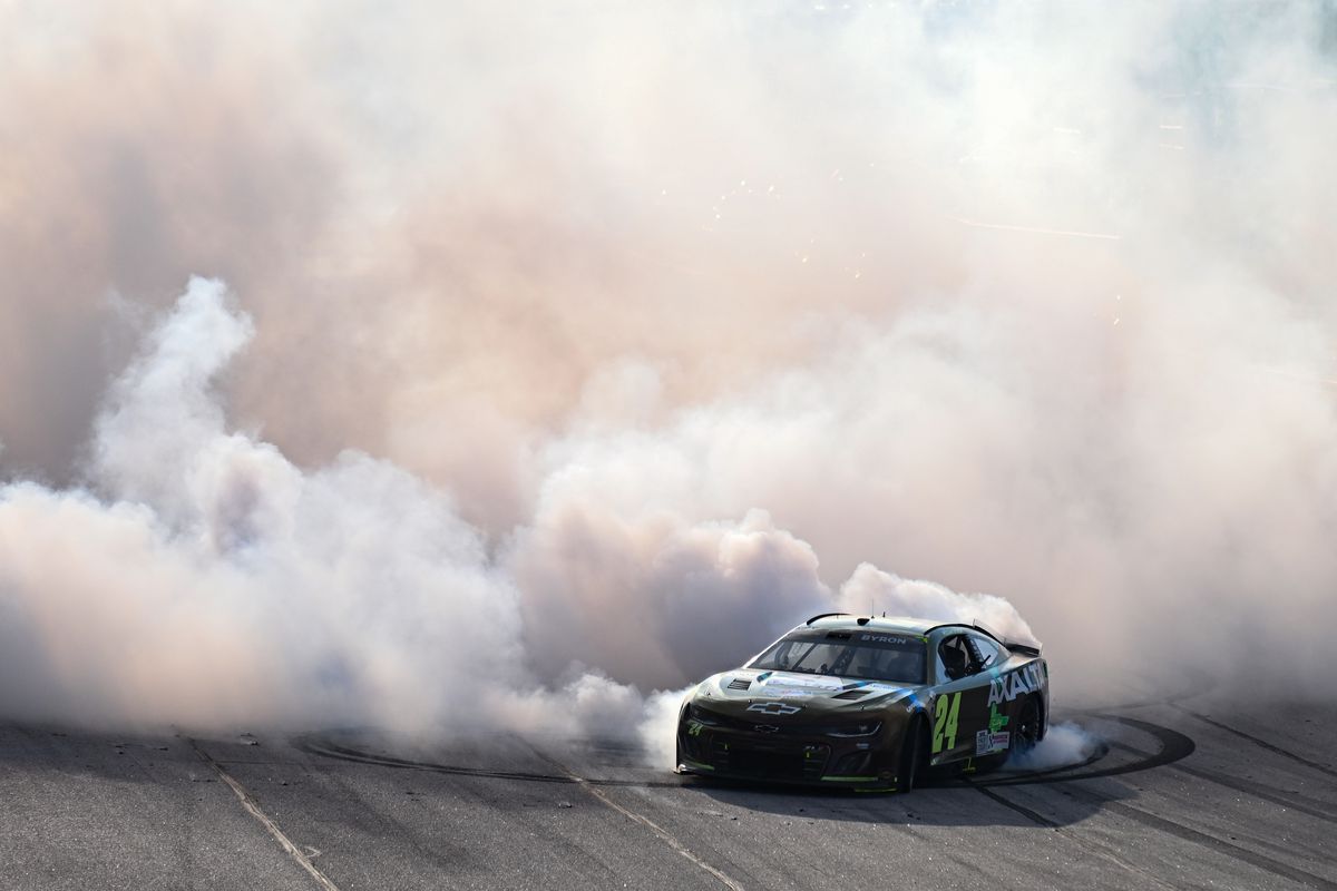 William Byron, driver of the #24 Axalta Throwback Chevrolet, celebrates with a burnout after winning the NASCAR Cup Series Goodyear 400 at Darlington Raceway on May 14, 2023 in Darlington, South Carolina.