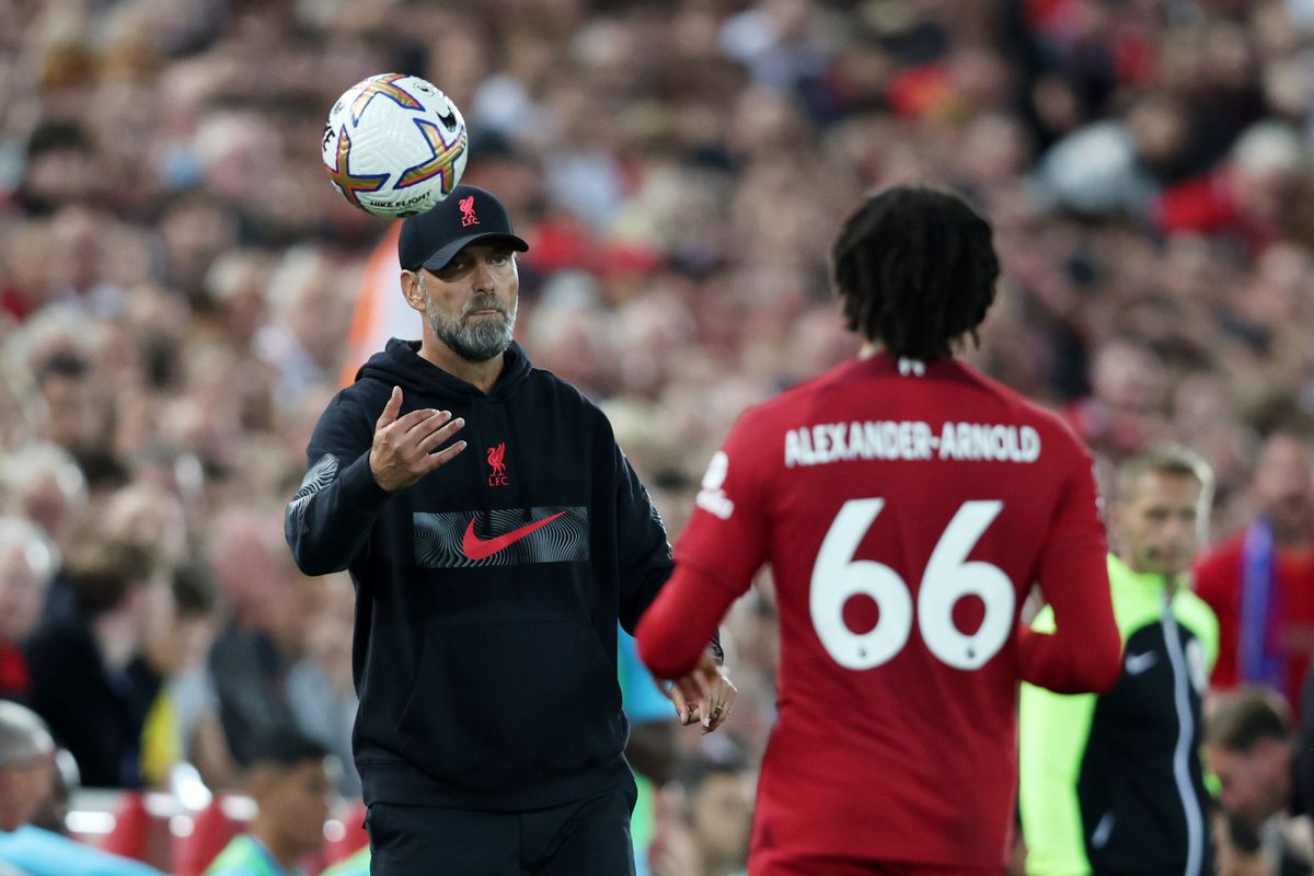 Liverpool Manager, Jurgen Klopp throws the ball to Trent Alexander-Arnold of Liverpool during the Premier League match between Liverpool FC and Crystal Palace at Anfield on August 15, 2022 in Liverpool, England.