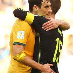 Mile Jedinak of Australia and Sergio Ramos of Spain hug