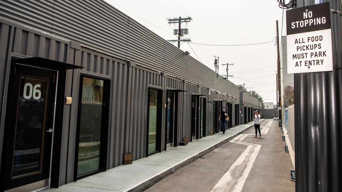 Lines of black shipping containers in a row.