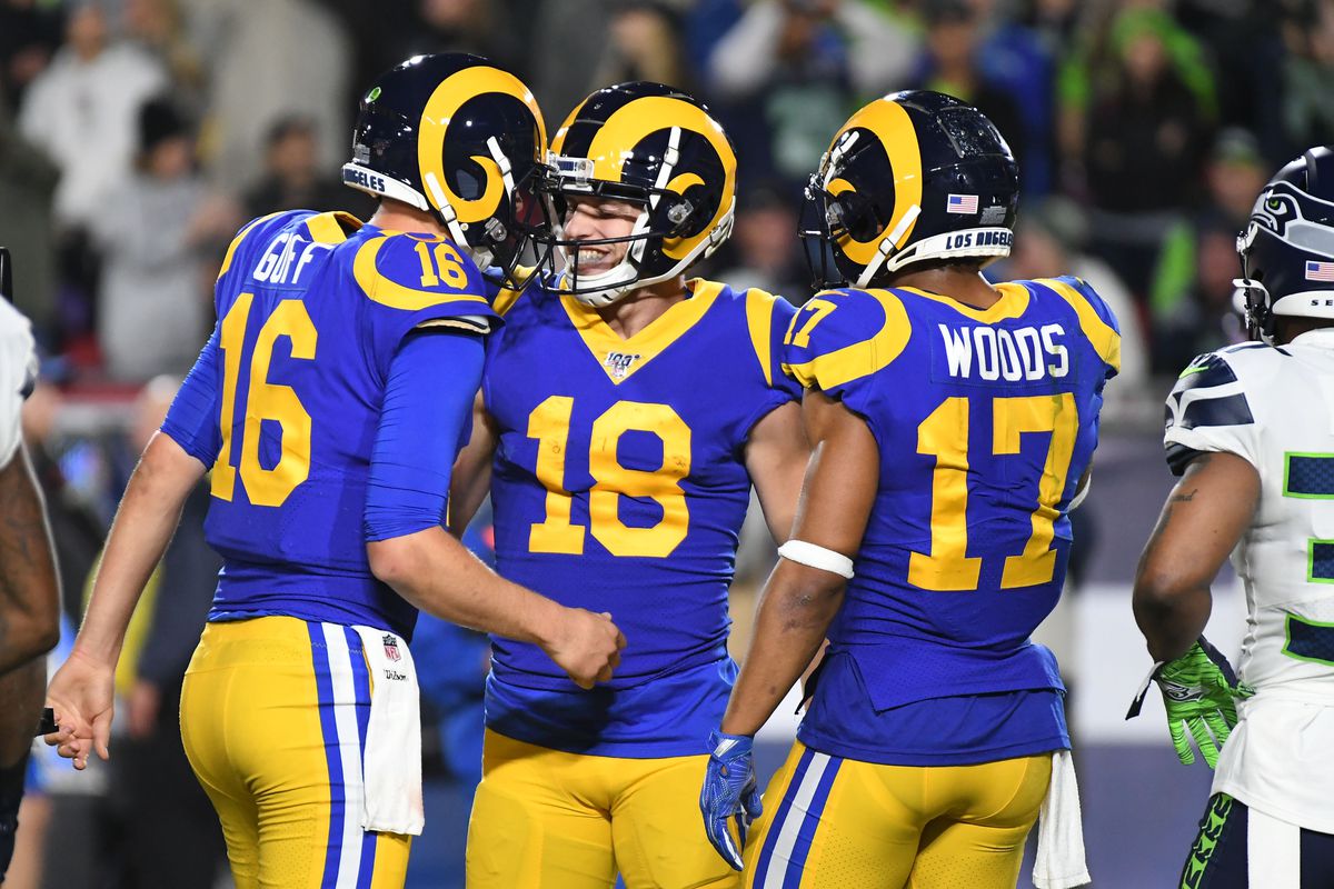 Los Angeles Rams wide receiver Cooper Kupp celebrates with quarterback Jared Goff and wide receiver Robert Woods after scoring a touchdown against the Seattle Seahawks in the first half of a NFL game at Los Angeles Memorial Coliseum.
