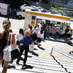 Customers wait in line at the Chow Truck at the Gallivan Center in Salt Lake City on Thursday, June 6, 2013.