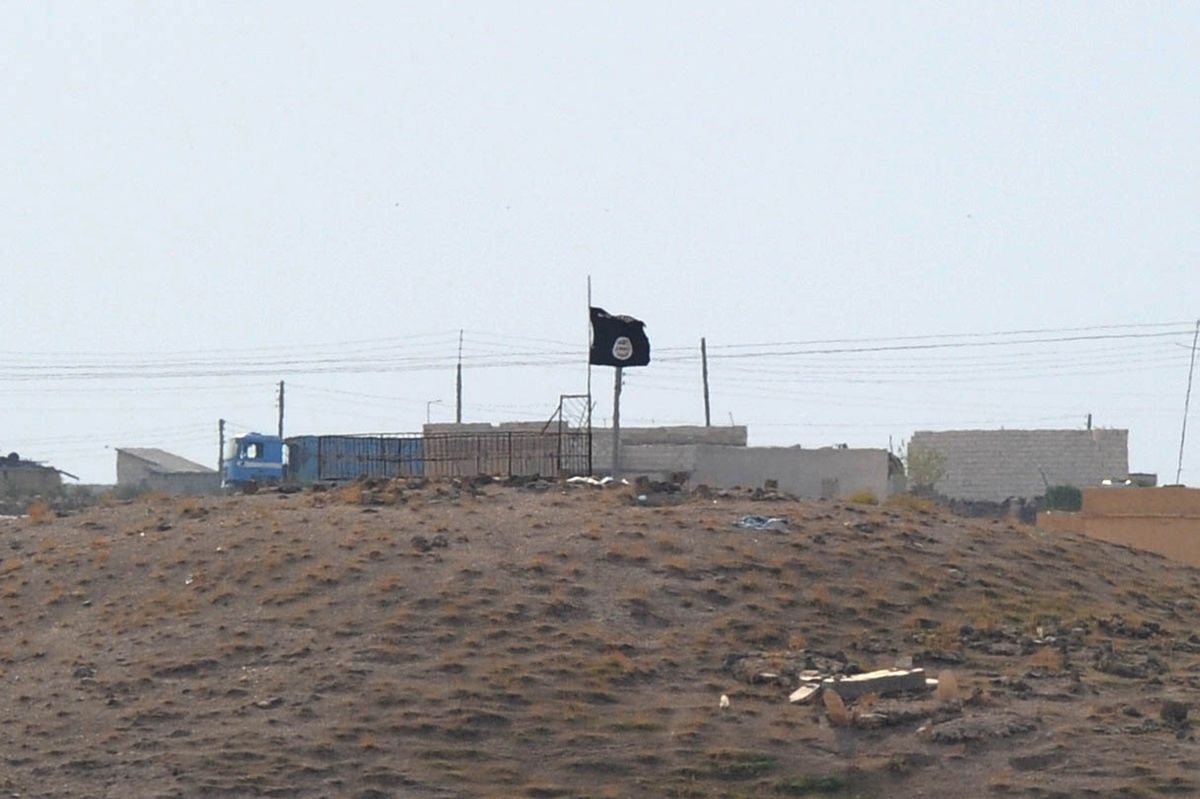 An ISIS black flag flies near the Syrian town of Kobani on October 27, 2014.