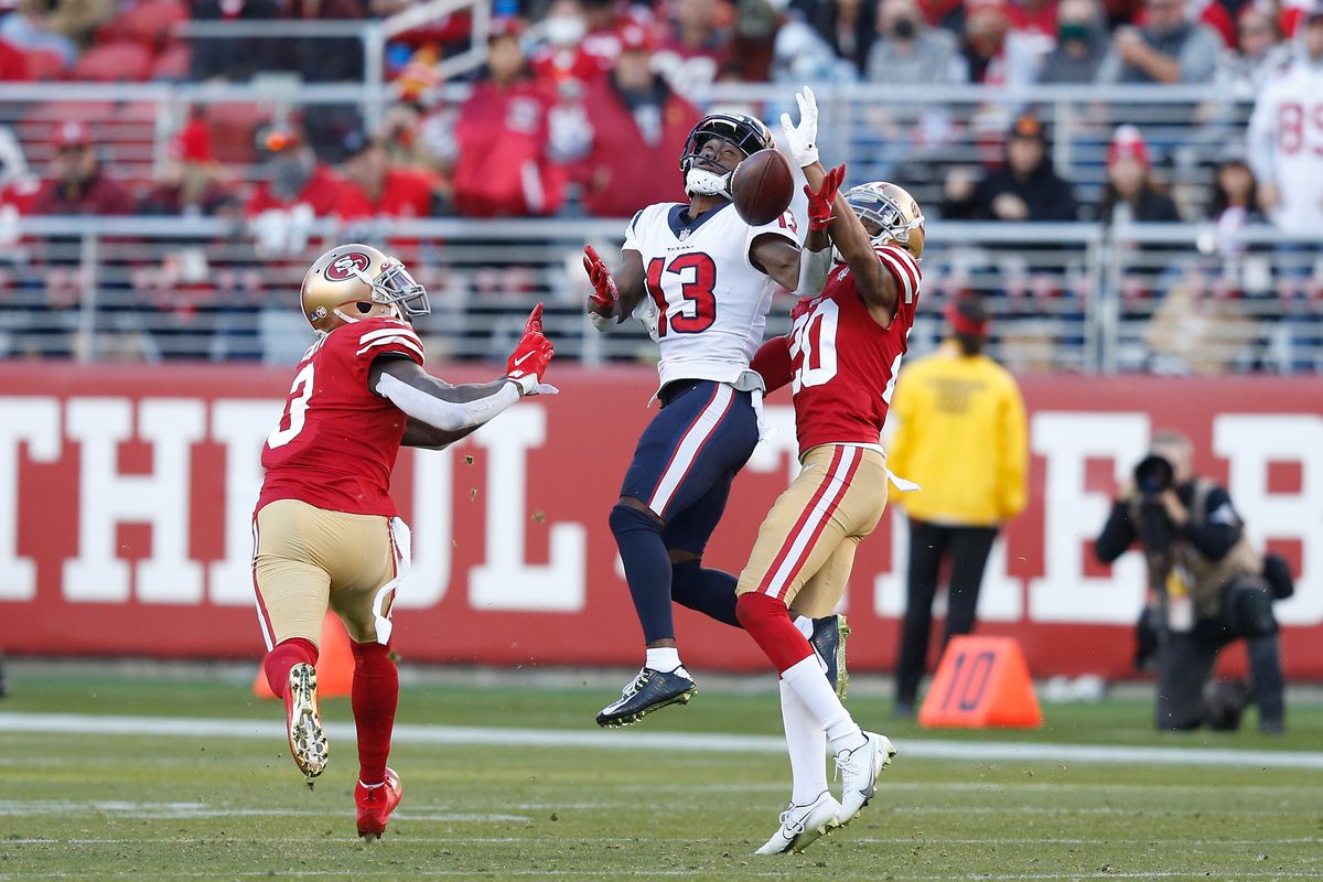 Brandin Cooks #13 of the Houston Texans makes a catch against Jaquiski Tartt #3 and Ambry Thomas #20 of the San Francisco 49ers in the third quarter at Levi’s Stadium on January 02, 2022 in Santa Clara, California. The play was brought back due to an offensive penalty.
