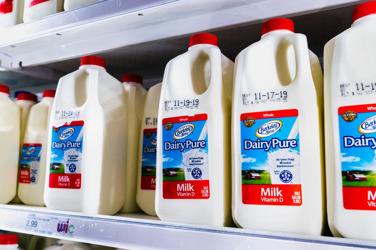 A grocery store aisle displaying half-gallon jugs of DairyPure milk.