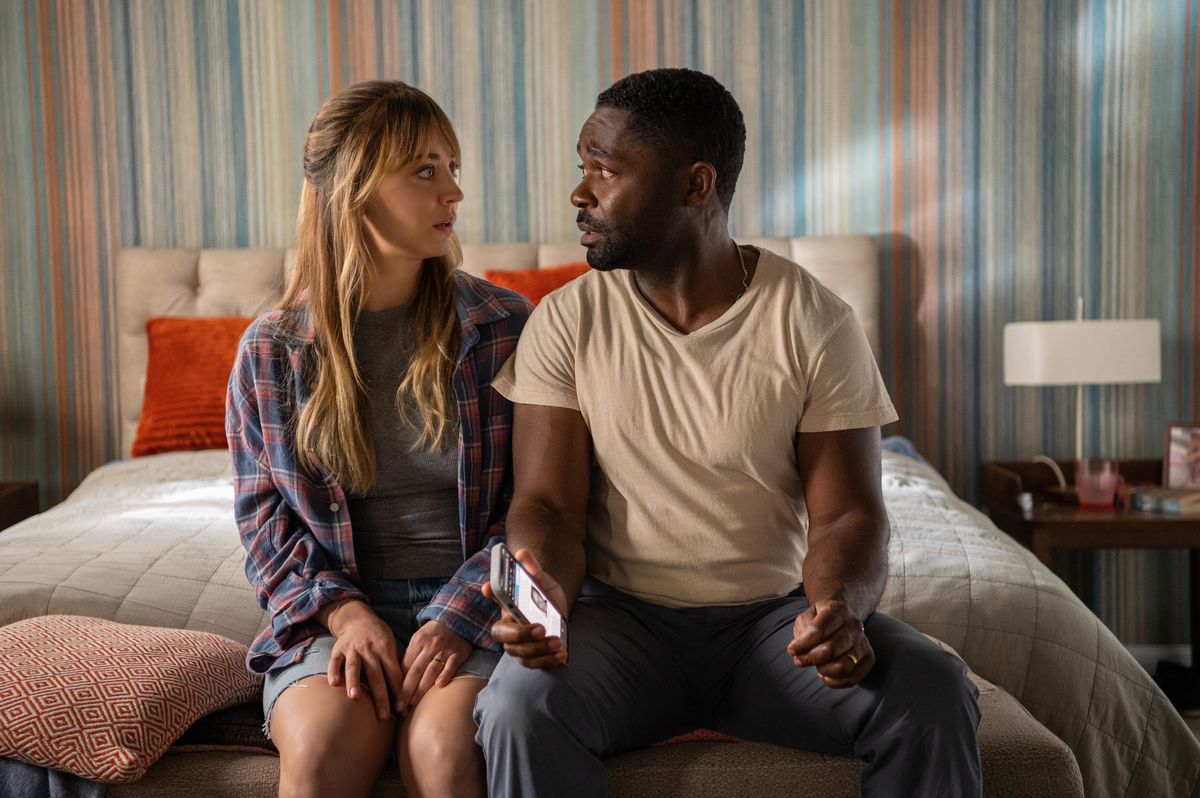 David Oyelowo looks at Kaley Cuoco with concern in his eyes while they sit together on a bed in Role Play