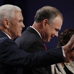 Democratic vice-presidential nominee Sen. Tim Kaine leaves the stage with Republican vice-presidential nominee Gov. Mike Pence during the vice-presidential debate at Longwood University in Farmville, Va., Tuesday, Oct. 4, 2016. Right is Anne Holton, wife of vice-presidential candidate Sen. Tim Kaine. (AP Photo/Patrick Semansky)