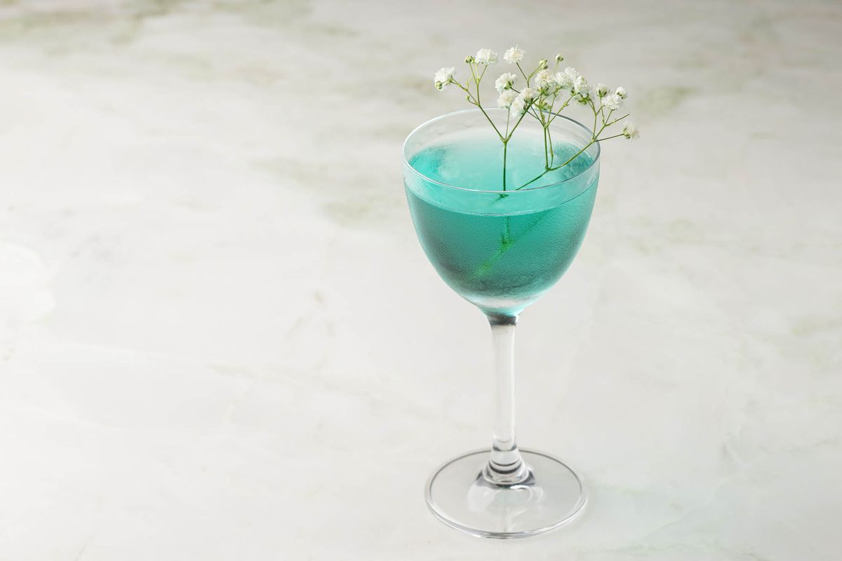A blue cocktail garnished with baby’s breath at Dante Beverly Hills.