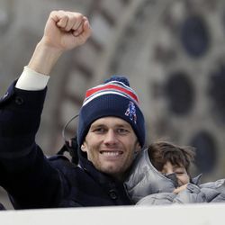 New England Patriots quarterback Tom Brady waves during a parade in Boston Wednesday, Feb. 4, 2015, to honor the Patriots' victory over the Seattle Seahawks in Super Bowl XLIX Sunday in Glendale, Ariz. 
