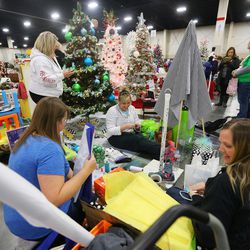 Members of the Allen Family decorate a tree in honor of Avery Allen, a member of their family who almost drowned, in preparation for the Festival of Trees at the South Towne Center in Sandy on Monday, Nov. 28, 2016. The festival runs Wednesday, Nov. 30 through Saturday, Dec. 3, from 10 a.m. to 10 p.m. each day.